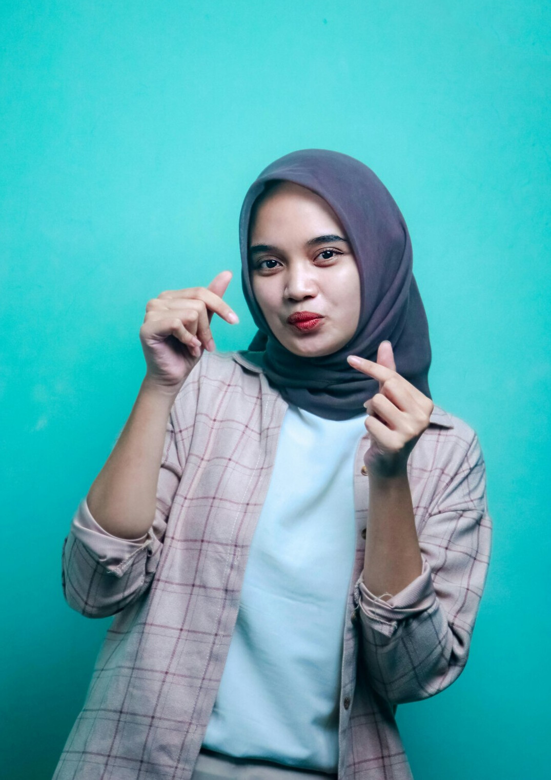 Studio portrait of a young Malaysian Malay woman in business casual attire