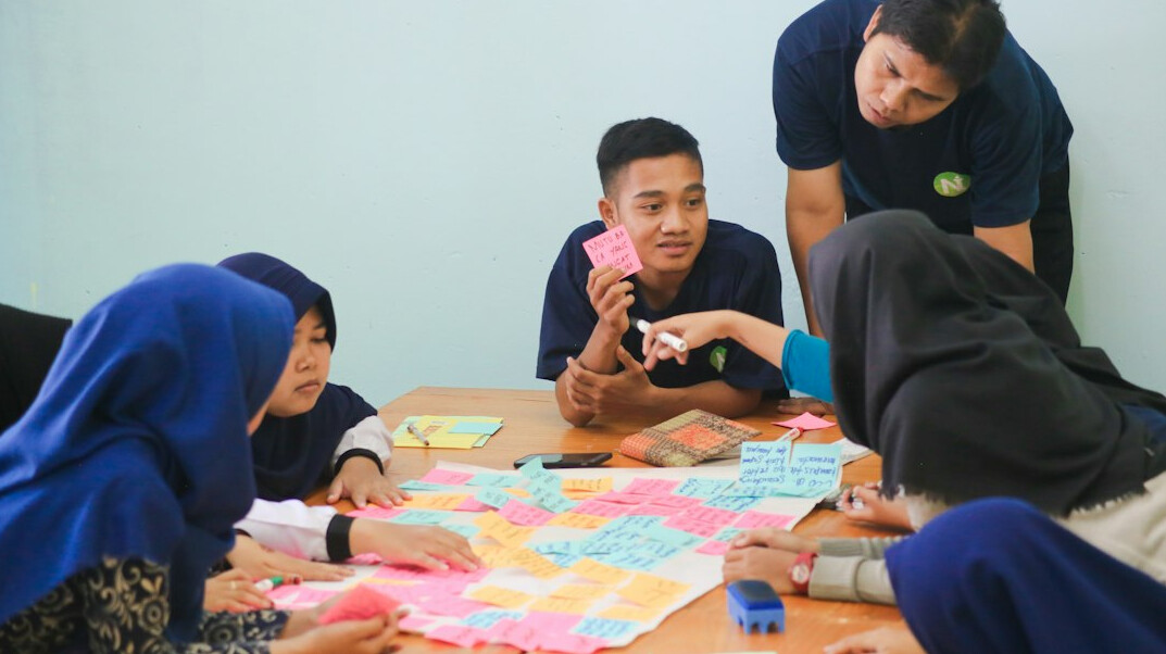 students coding together in classroom