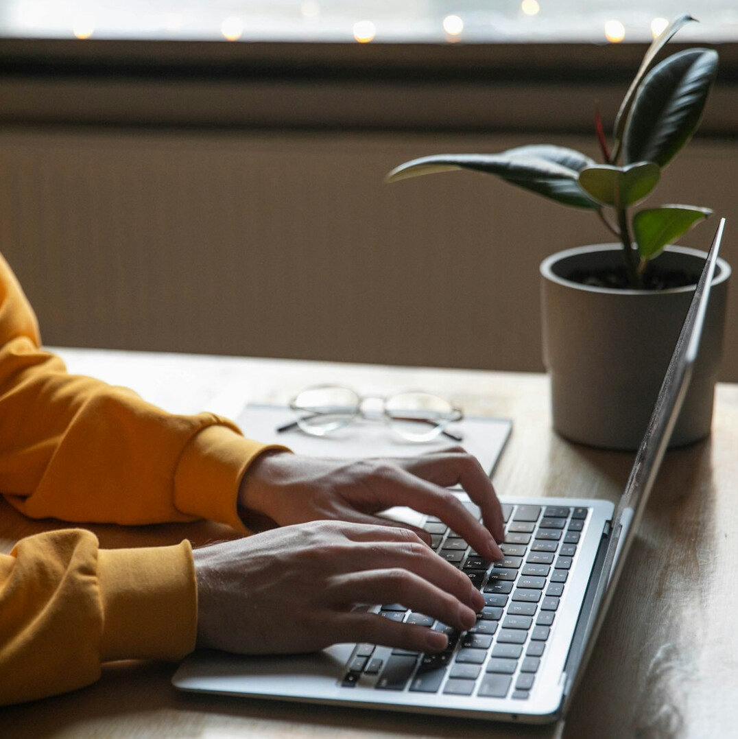 person coding on laptop at desk